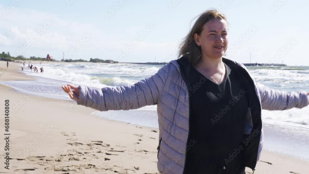 A woman walks along the seashore enjoying the waves. Holidays at sea. A woman walks along the seashore enjoying the waves. Holidays at sea.