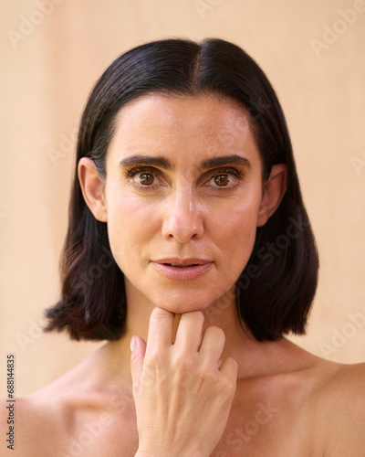 Beauty Portrait Of Smiling Mature Woman With Bare Shoulders Against Natural Background