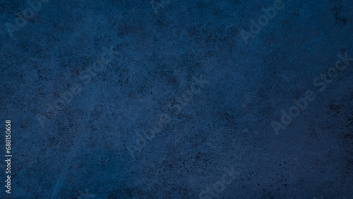 A dark blue grunge picturesque wall texture with stains and scratches on concrete surface  photo