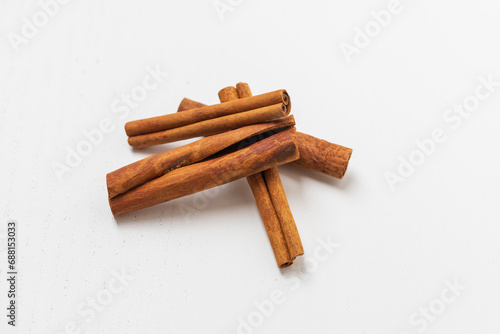 All the cinnamon is on the pile, the background is white. Flatlay photography photo