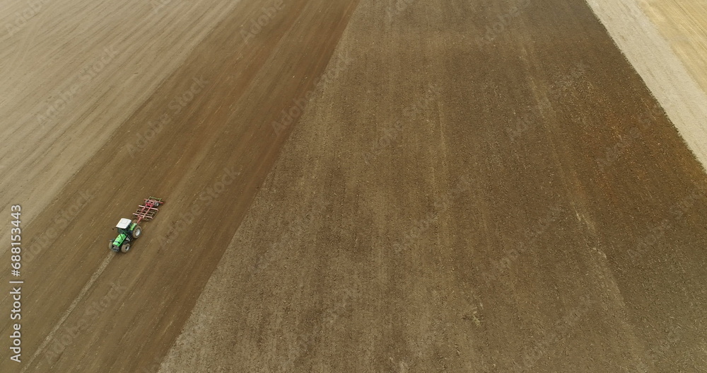 Obraz premium Agriculture- Tractor plowing GMO Free agricultural field.