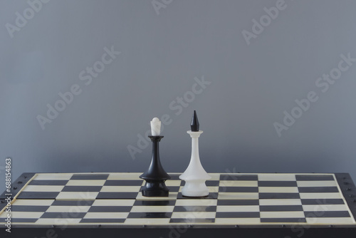 Fotografie A chess king and queen standing together on a chessboard