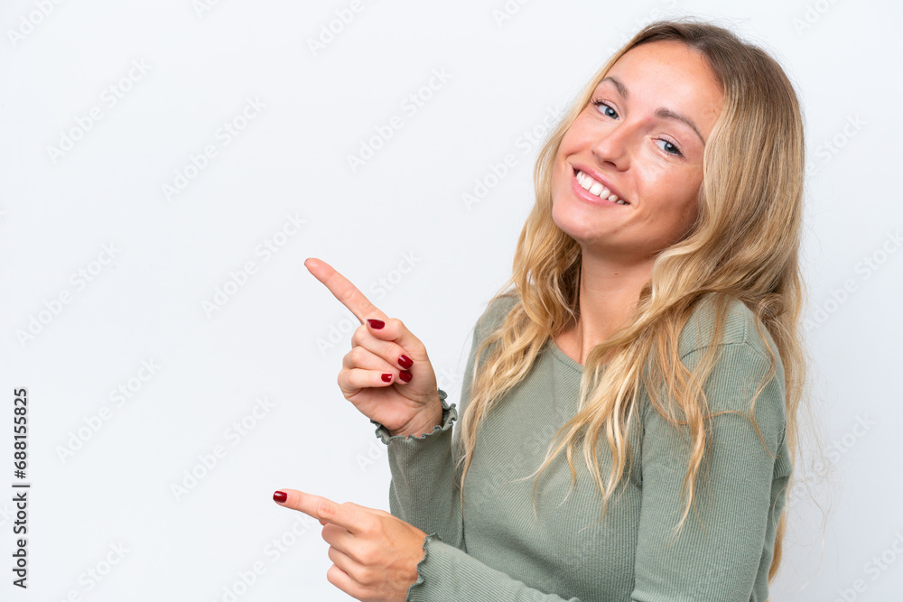 Young Russian woman isolated on white background pointing finger to the side and presenting a product Young Russian woman isolated on white background pointing finger to the side and presenting a product