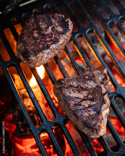 Beef rumpsteak cooked on a cast iron grate on a charcoal grill
