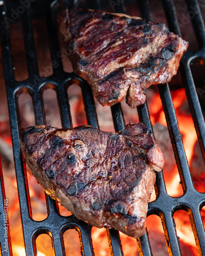 Beef rumpsteak cooked on a cast iron grate on a charcoal grill