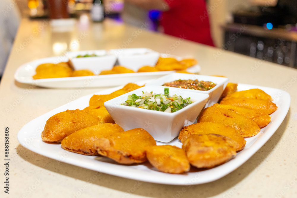 empanada colombiana on a plate with chili