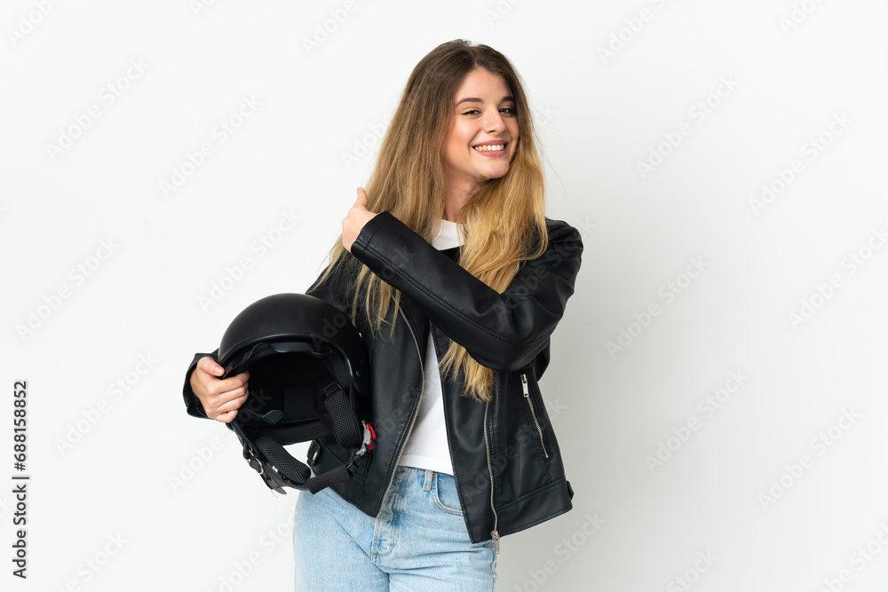 Woman holding a motorcycle helmet isolated on white background pointing back Woman holding a motorcycle helmet isolated on white background pointing back