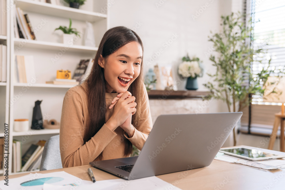Beautiful young woman using laptop while working in home office. Businesswoman happy and smiling at indoors. Beautiful young woman using laptop while working in home office. Businesswoman happy and smiling at indoors.