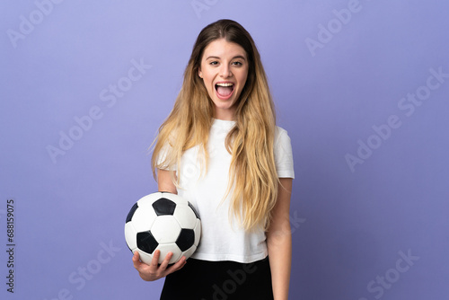Young blonde football player woman isolated on purple background with shocked facial expression © luismolinero