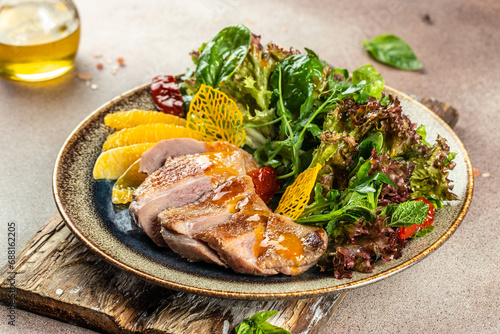 Roast duck breast with orange and greens. Restaurant menu, dieting, cookbook recipe top view