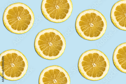 lemmon pattern on bright light blue background. Minimal flat lay food texture. Summer abstract trendy fresh concept.