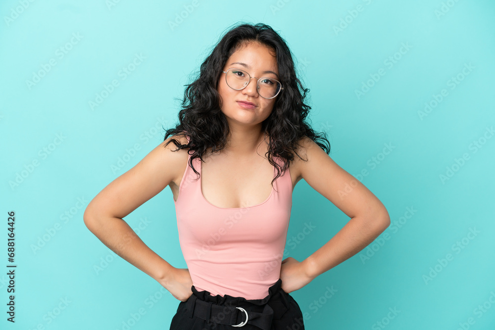 Young asian woman isolated on blue background angry Young asian woman isolated on blue background angry