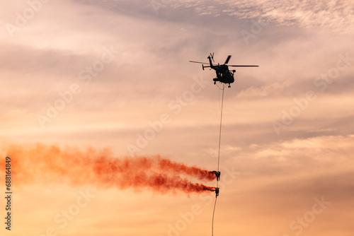 Indian Navy Commandos (MARCOS) performing aerial display from an Indian Navy helicopter