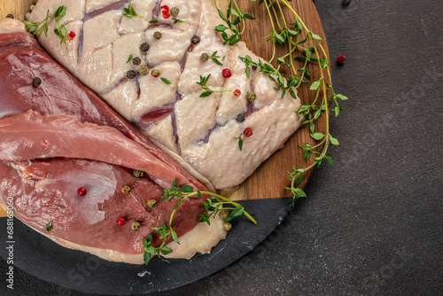 Raw duck breast fillet fresh meat on a dark background. top view. copy space for text photo