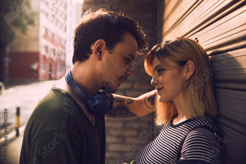 Young couple in love face to face embracing on city street photo