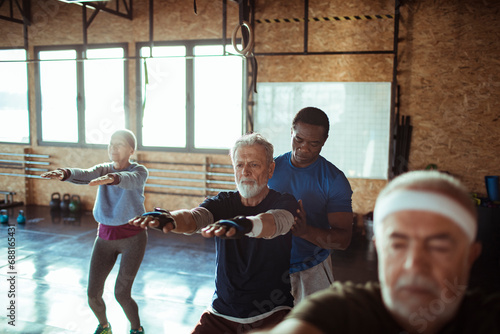 Senior fitness class with personal trainer at the gym photo