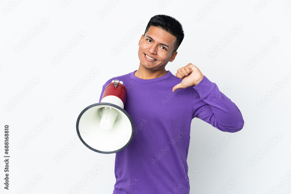 Young Ecuadorian man isolated on white background holding a megaphone and proud and self-satisfied Young Ecuadorian man isolated on white background holding a megaphone and proud and self-satisfied
