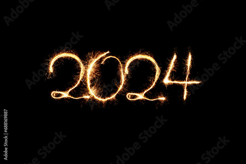 New Year 2024 sparkler golden light. Sparklers draw figures 2024. Bengal lights and letter. Holidays 2024 card. photo