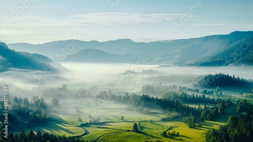 Peaceful landscape of foggy sunny green mountain valleys in early morning in spring © Юлия Блажук