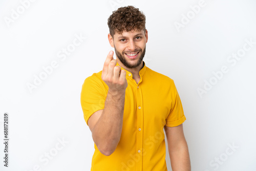 Young handsome caucasian man isolated on white background making money gesture