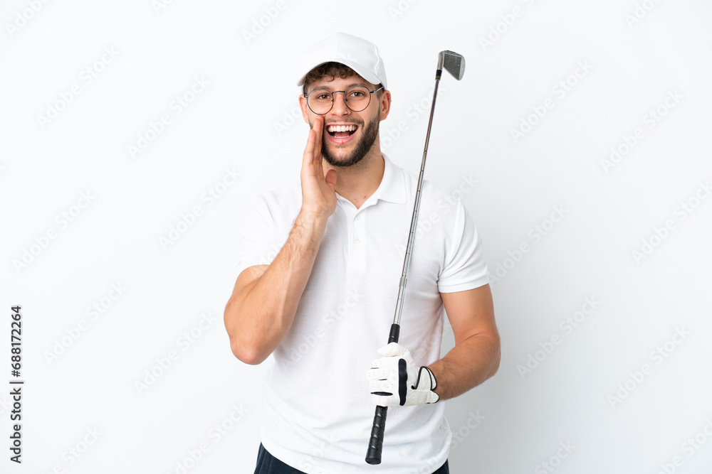 Handsome young man playing golf isolated on white background shouting with mouth wide open Handsome young man playing golf isolated on white background shouting with mouth wide open