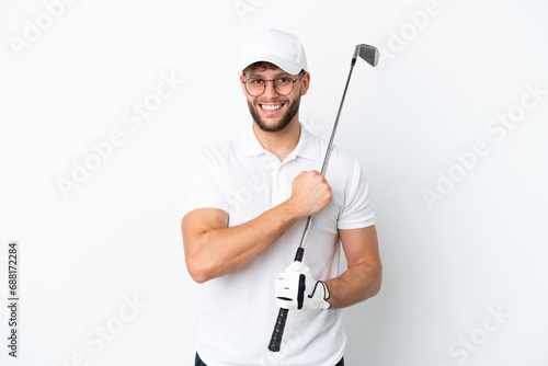 Handsome young man playing golf isolated on white background celebrating a victory