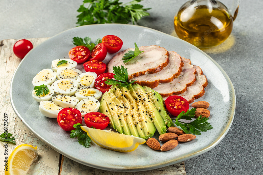breakfast avocado, eggs, chicken fillet and cherry tomatoes. Ketogenic diet food on a light background top view. copy space breakfast avocado, eggs, chicken fillet and cherry tomatoes. Ketogenic diet food on a light background top view. copy space