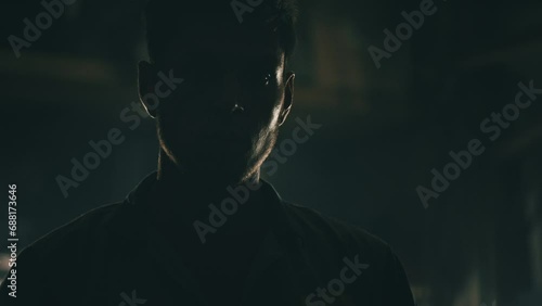 Man standing in silhouette in a dark room. 4K