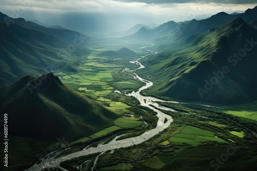 Aerial view of a river going through green mountains