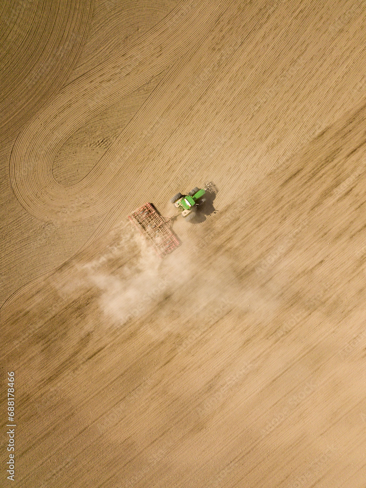 Aerial view of tractor cultivating soil field