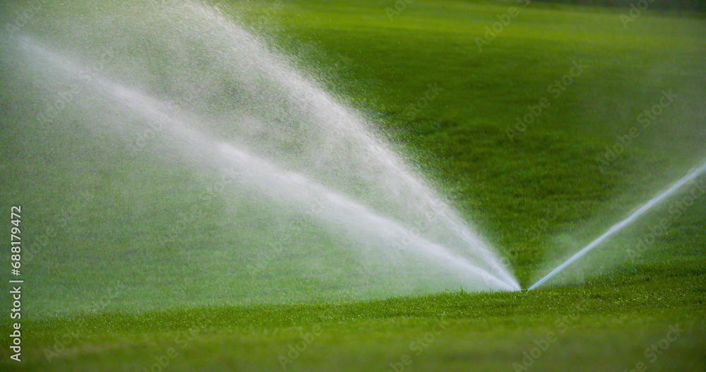 medium shot of grass sprinkler splashes water over the lawn medium shot of grass sprinkler splashes water over the lawn