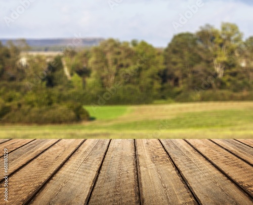 The empty wooden table top at farm background
