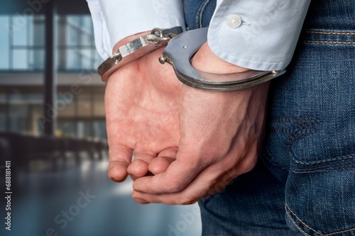 Arrested criminal angry man with handcuffs
