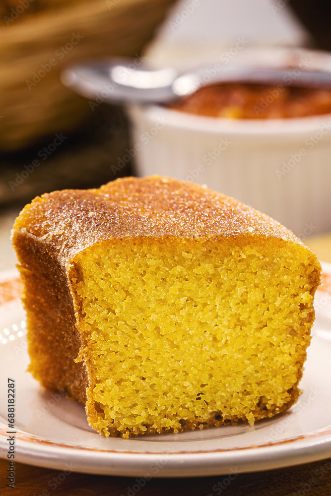 slice of cornmeal cake, traditional homemade corn cake from Brazil in June parties, with rustic sweets in the background slice of cornmeal cake, traditional homemade corn cake from Brazil in June parties, with rustic sweets in the background
