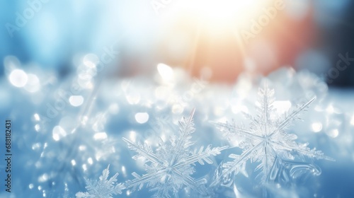 pure white snowflakes on glowing in the sunlight on light blue background photo