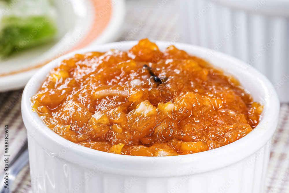 Brazilian pumpkin jam or pudding, with candied pumpkin jam in the background, tradition of the Brazilian June festivals Brazilian pumpkin jam or pudding, with candied pumpkin jam in the background, tradition of the Brazilian June festivals