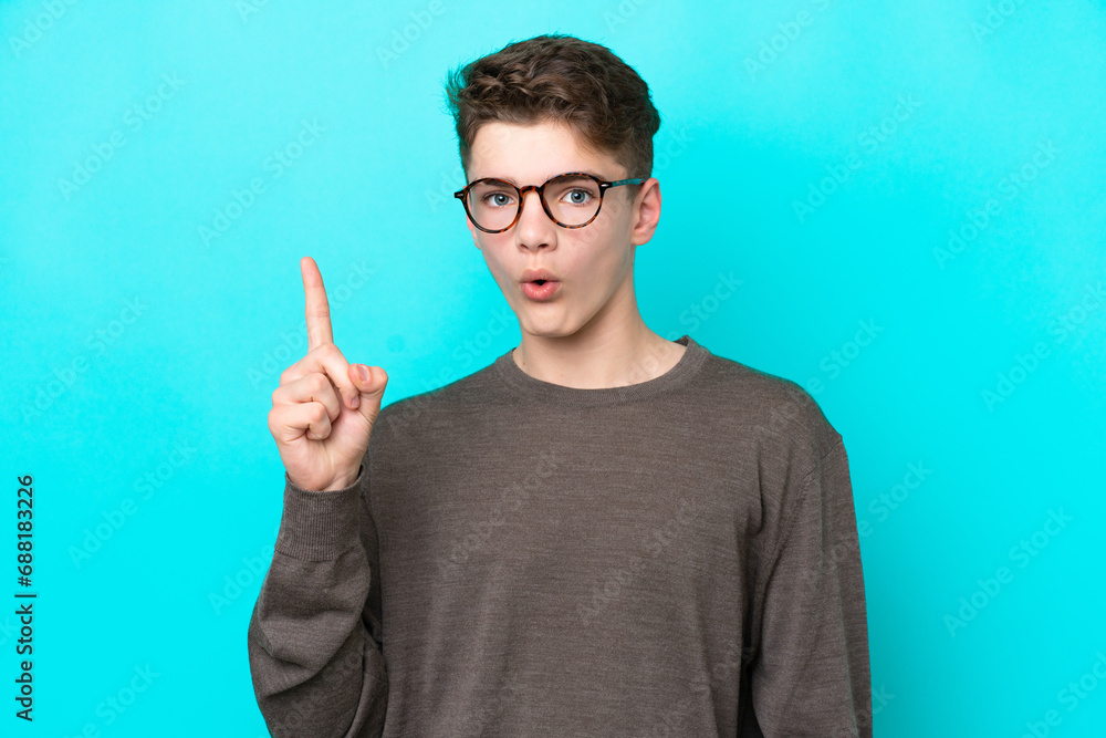 Fototapeta premium Teenager Russian man isolated on blue background intending to realizes the solution while lifting a finger up