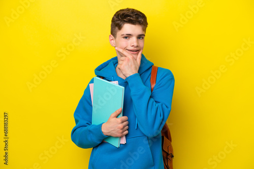 Teenager Russian student man isolated on yellow background happy and smiling