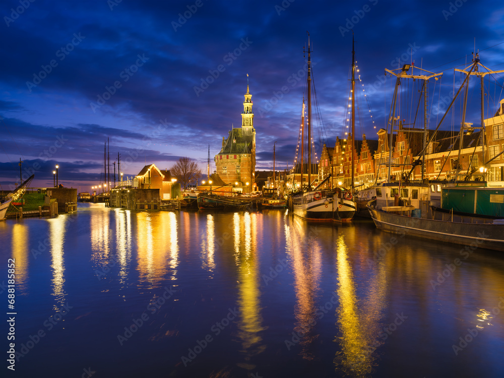Hoorn, Netherlands. An ancient harbor and marina. Old sailing ships. View of houses during evening. A cityscape in the evening. Postcard, background, wallpaper.