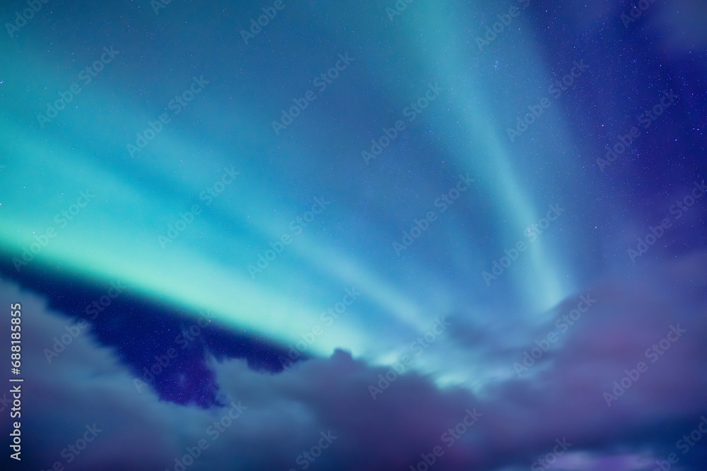 Sky background with northern lights. Aurora borealis. Northern lights as a background. Night winter landscape with aurora. Natural background.