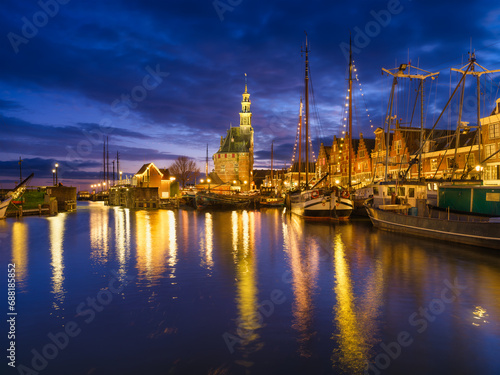 Hoorn, Netherlands. An ancient harbor and marina. Old sailing ships. View of houses during evening. A cityscape in the evening. Postcard, background, wallpaper.