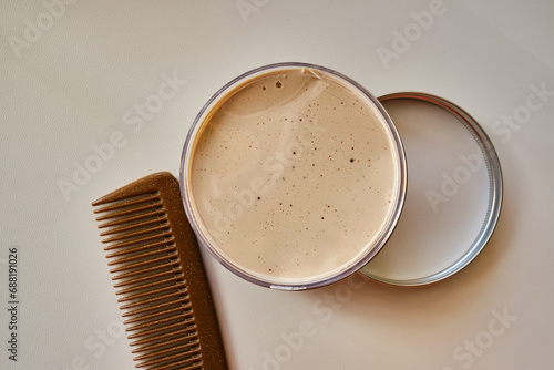 Tableau sur toile Clay, pomade, wax, gel or mousse in a round metal box for hair styling