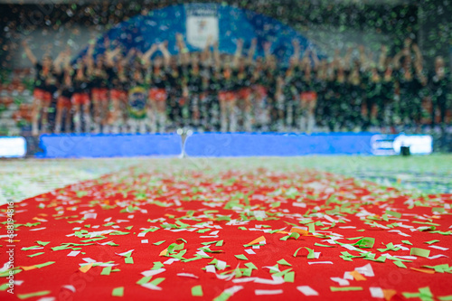 Confetti on the red carpet and team of sports chamions in the background photo