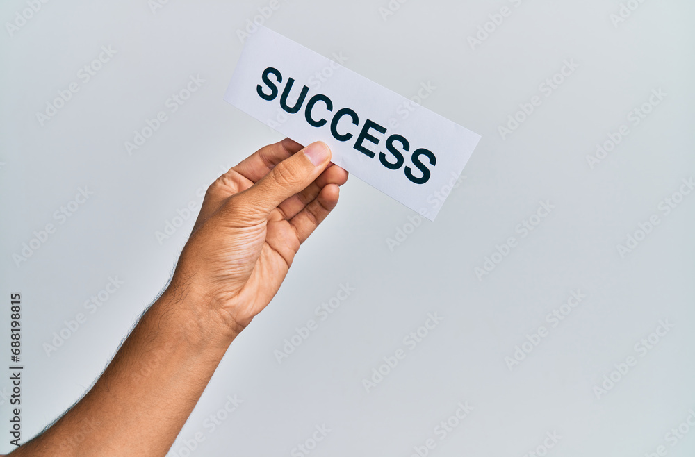 Hand of caucasian man holding paper with success word over isolated white background
