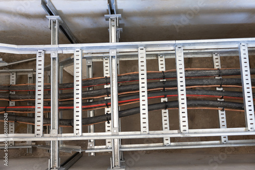 electric cable duct on a metal frame, cable pulling industrial area in a tray , industrial wiring rail , knit done photo