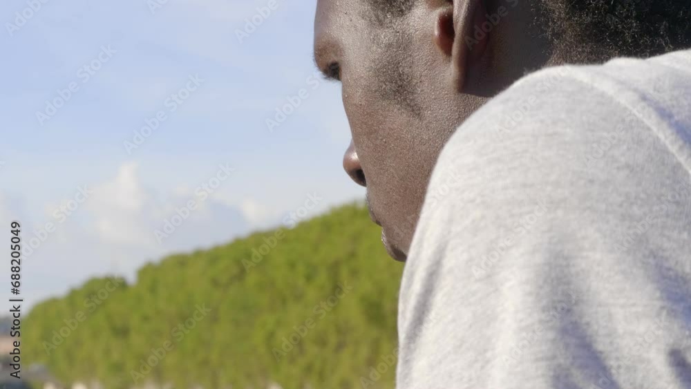steady cam on thoughtful black man looking at the river with absorbed gaze steady cam on thoughtful black man looking at the river with absorbed gaze