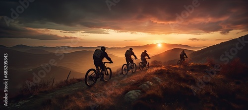 Mountain bikers riding on a mountain trail during sunset