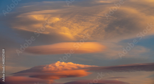 Beautiful lenticular clouds in the sky at sunset © Miguel Ángel RM