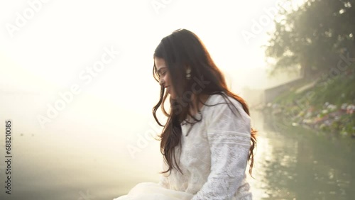 A beautiful Indian girl, wearing a traditional dress, outdoor nature background photo