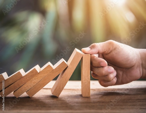 Hand pull out wooden block to prevent and stop falling domino ,It is a symbol of protection